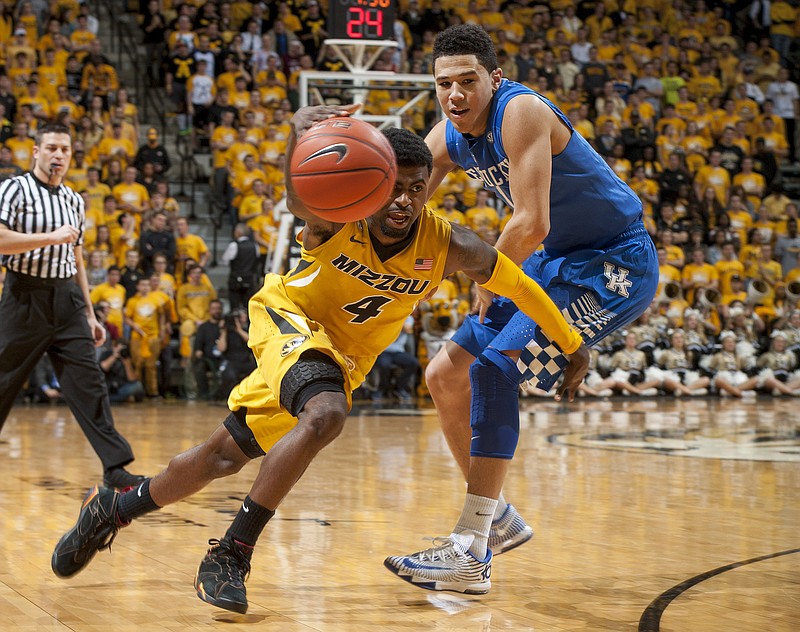 Missouri's Tramaine Isabell, left, dribbles around Kentucky's Devin Booker during the first half of an NCAA college basketball game Thursday, Jan. 29, 2015, in Columbia, Mo. 