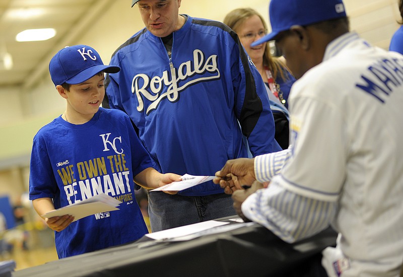 Andrew Dowden accepts an autograph from former Royal first baseman John Mayberry.