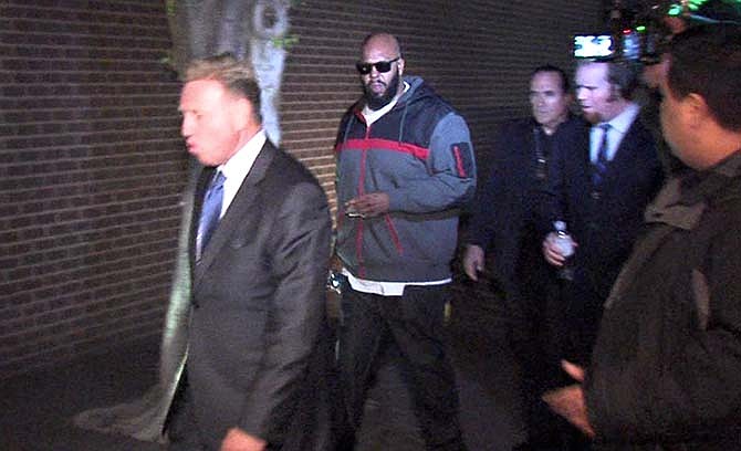 This image from video shows Death Row Records founder Marion "Suge" Knight, right, walking into the Los Angeles County Sheriffs department early Friday morning Jan. 30, 2015 in connection with a hit-and-run incident that left one man dead and another injured.