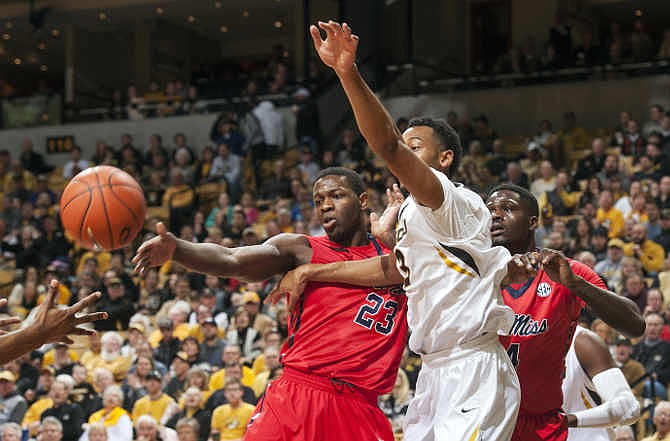 Missouri's Johnathan Williams III, center, battles Mississippi's Dwight Coleby, left, and Mississippi's M.J. Rhett, right, for a rebound during the first half of an NCAA college basketball game Saturday, Jan. 31, 2015, in Columbia, Mo. 