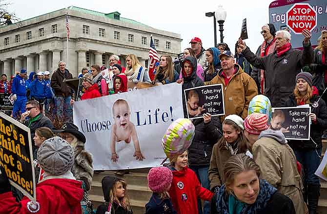 Participants in the MidWest March for Life make their way down the stairs to the south lawn at the Missouri Capitol Saturday morning before the start of the rally in the Rotunda following their march.