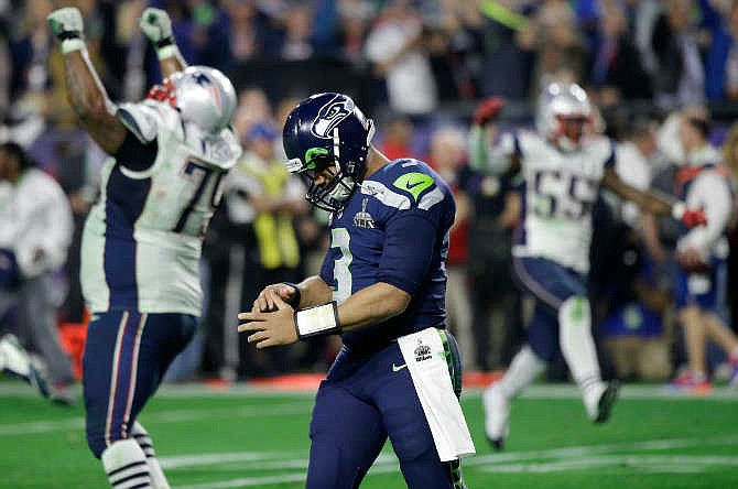 Seattle Seahawks quarterback Russell Wilson (3) walks off the field after throwing an interception to New England Patriots strong safety Malcolm Butler during the second half of NFL Super Bowl XLIX football game Sunday, Feb. 1, 2015, in Glendale, Ariz.