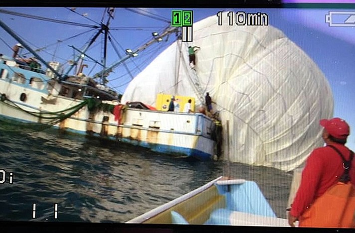 This image from video shows the recovery boat collecting the balloon envelope 4 miles offshore in Baja California about 300 miles north of the popular beach destination of Cabo San Lucas Saturday.
