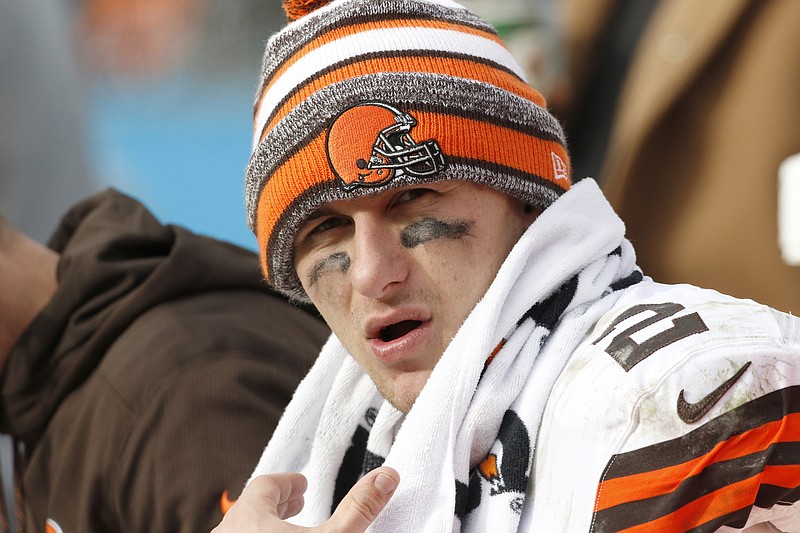 Browns quarterback Johnny Manziel sits on the bench during the second half of a game last season against the Panthers in Charlotte, N.C.