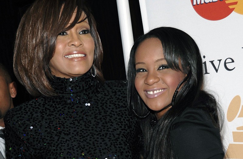  In this Feb. 12, 2011, file photo, singer Whitney Houston, left, and daughter Bobbi Kristina Brown arrive at an event in Beverly Hills, Calif. Messages of support were being offered Monda as people awaited word on Brown, who authorities say was found face down and unresponsive in a bathtub over the weekend in a suburban Atlanta home. 