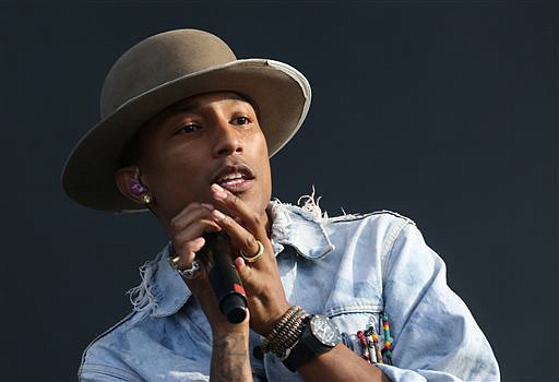In this July photo, Pharrell Williams performs on the main stage at Wireless festival in Finsbury Park, in London. Pharrell and Sam Smith will perform at the Grammys Sunday