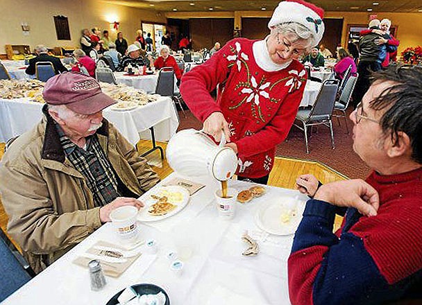 In this December 2011 photo, Connie Howe pours coffee for Ronald Read, left, and Dave Smith during the Charlie Slate Memorial Christmas breakfast at the American Legion in Brattleboro, Vermont. Read, a former gas station employee and janitor who died in June at age 92, had a long-time habit of foraging for firewood but also had a hidden talent for picking stocks.