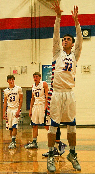 California senior Dylan Norton shoots a free throw in Thursday's game against Green Ridge, while teammates Ethan Hodges (23) and Allan Burger (33) watch. The Pintos beat the visiting Tigers, 58-30.