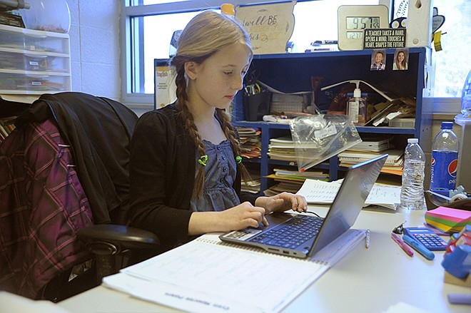 Eugene Elementary School fifth-grader Grace Morgan takes a computer-based test on "Tuck Everlasting" in one of the many ways a Chromebook for each teacher is helping students.