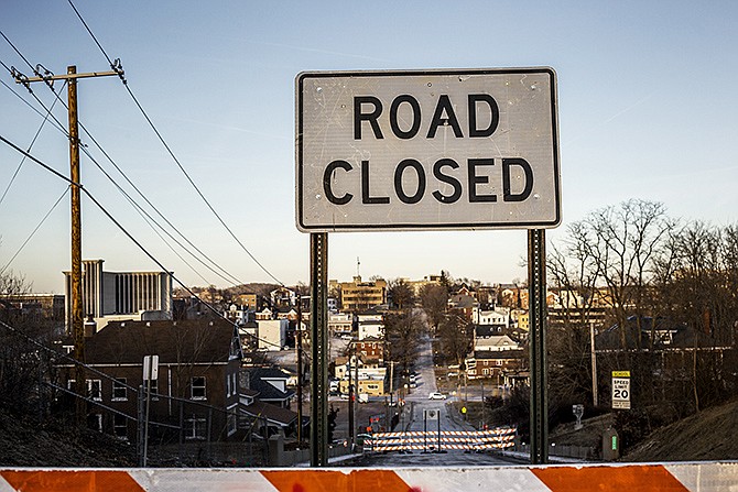 Signs mark a road and sidewalk closure on the Jackson Street overpass Thursday afternoon. Beginning Saturday morning, MoDOT will be demolishing this and the Chestnut Street overpasses as part of the Lafayette Interchange project that will widen the Expressway. The demolitions will cause a U.S. 50 detour throughout the weekend.