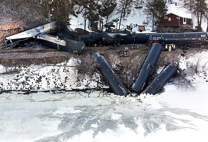 Crews work at the scene of a Canadian Pacific freight train derailment north of Dubuque, Iowa, Thursday. Three railcars plunged into the river, and eight leaked ethanol after the derailment Wednesday. Railroad officials said it's unclear how much ethanol has leaked into the Mississippi River from the train, but that they were working to monitor the environmental impact and offload fuel from the train. 