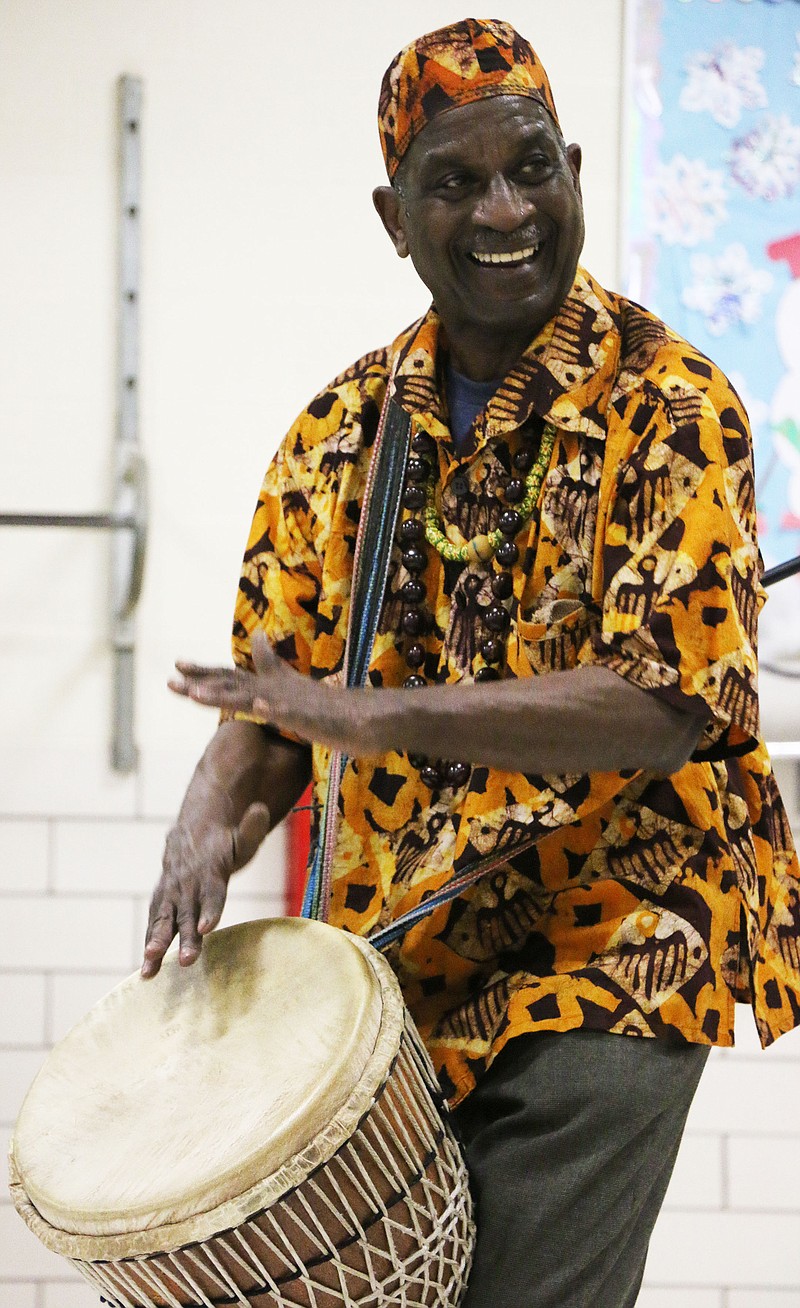 Kenya Ajanaku, executive director of the Harambee Institute, plays the drums for McIntire Elementary School Wednesday afternoon in honor of Black History Month. Ajanaku visited several schools in the district Wednesday.