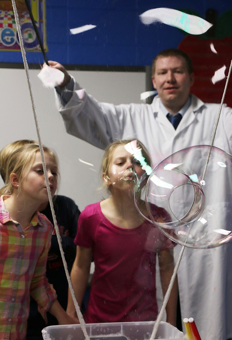 McIntire students blow giant bubbles with the help of a William Woods University science demo team. WWU Assistant Professor of Physics Vern Hart helped students create giant bubbles at McIntire's S.T.E.A.M night Thursday.