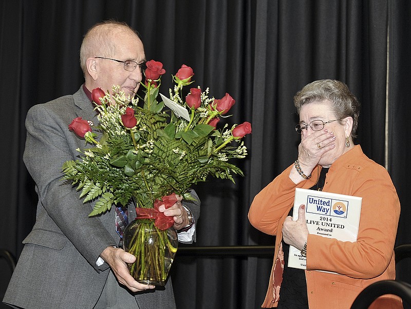 Alan Mudd presented a bouquet of red roses to his wife, Betty, after she accepted the 2014 Live United Award for her volunteerism at the United Way of Central Missouri office.