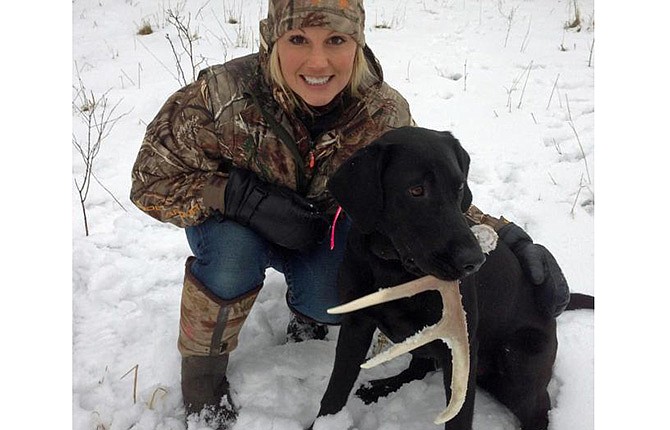 Tiffany Lakosky and her antler dog Mattie show off a shed they found. 