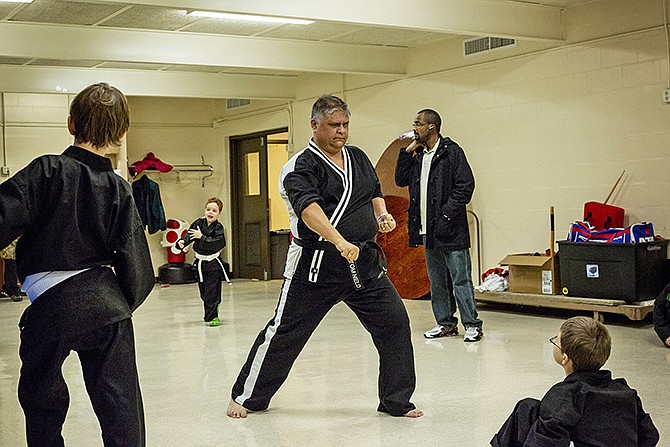 Karate instructor Tom Nield runs through kata exercises between his beginners and advanced classes last week in the North Jefferson City Multipurpose Building. Through Parks and Recreation, Nield teaches weekly youth karate classes.