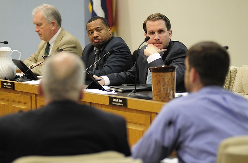 Jefferson City Council members Carlos Graham, top center, and Ken Hussey, top right, listened as city attorney Drew Hilpert, right, detailed some of the issues as the council discussed commercial waste removal services during a work session on Monday evening, Feb. 9, 2015.
