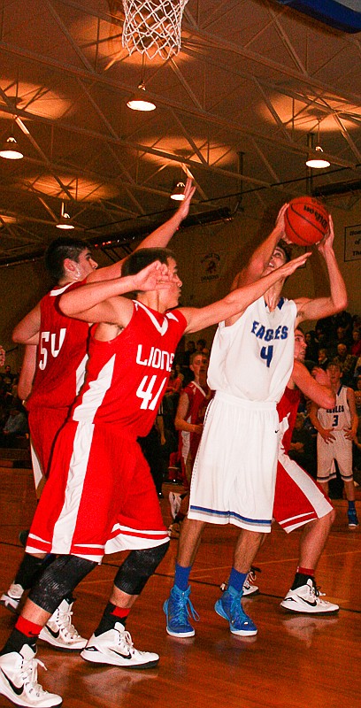 Jamestown freshman Trenton Barbour (4) gets ready to put up a shot, while two Tuscumbia defenders race toward him. The visiting Lions beat Jamestown, 56-51, on Tuesday, Feb. 3.