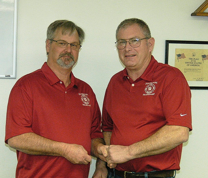 Democrat photo / David A. Wilson

Fire Chief Steve Walters, left, receives an award for 35 years of service with California Rural Fire Protection District presented by Board member Chris Clifford.