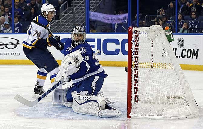 St. Louis Blues' T.J. Oshie scores past Tampa Bay Lightning goalie Ben Bishop during the first period of an NHL hockey game Thursday, Feb. 12, 2015, in Tampa, Fla.