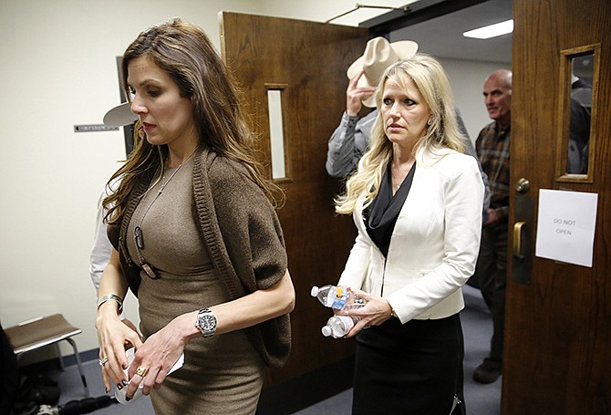 Taya Kyle, left, wife of slain Navy SEAL Chris Kyle, leaves the Erath County Donald R. Jones Justice Center courtroom following the days proceedings in Stephenville, Texas, during the capital murder trial of former Marine Cpl. Eddie Ray Routh on Wednesday. 