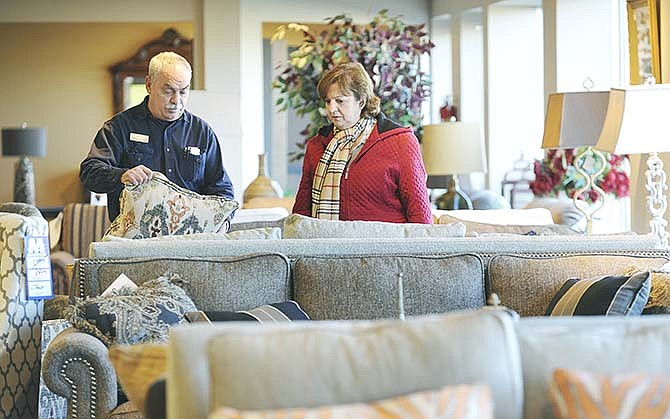 Salesman Gail Muri, left, helps customer Doris Lehmen select a couch and recliner at JC Mattress Factory in Jefferson City. The furniture store recently added about $500,000 worth of inventory, said owner Dave Mehmert, who expects a 15 percent increase in sales this year.