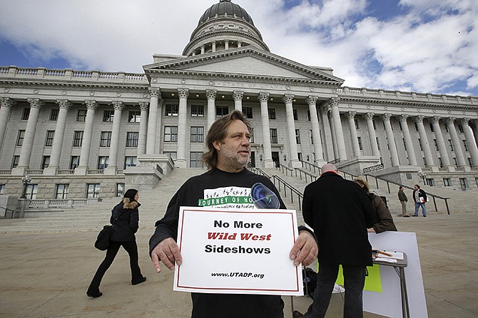 Randy Gardner of Salt Lake City, the older brother of Ronnie Lee Gardner, the last inmate to be killed by firing squad in Utah in 2010, protests in January with a group opposed to capital punishment plans over one lawmaker's plan to resurrect the use of firing squads, outside the Utah State Capitol, in Salt Lake City. 