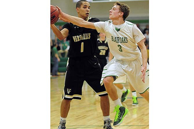 Blair Oaks' Cody Alexander steals the ball out of the hands of Versailles' Trey Woods following an inbounds pass by the Tigers in Friday's game in Wardsville.
