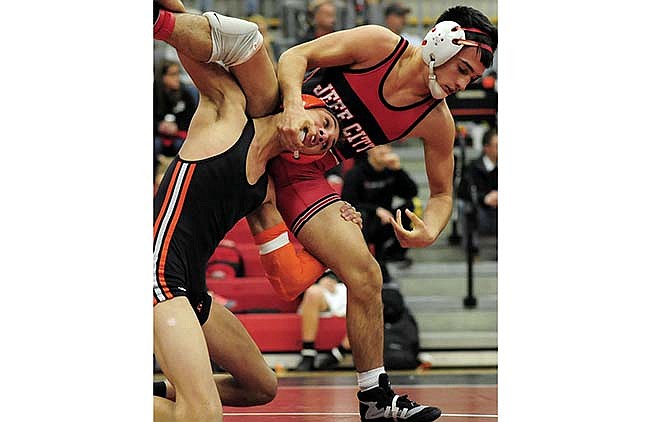 Jefferson City's Corbin Howard and Waynesville's Teyler Bruch lock horns in a 120-pound quarterfinal match Friday in the Class 4 District 3 Tournament.