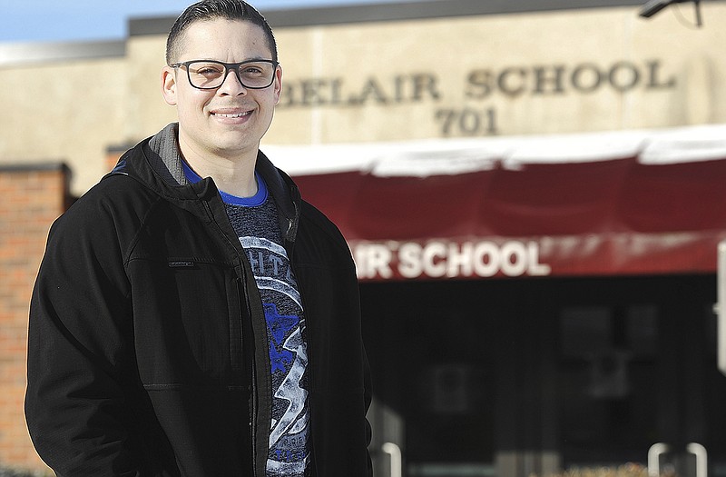 Derrick Smith poses outside of Belair School where he is an active dad. He is working on a program to get fathers more involved in their children's school activities.
