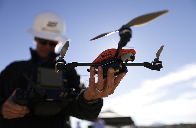 Former Navy helicopter pilot and San Diego Gas & Electric unmanned aircraft operator Teena Deering holds a drone as it is prepared for takeoff near Boulevard, Calif.
