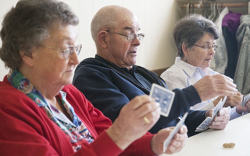 (From left) Betty Rountree, Homer Spradlin and Pat Butler of Auxvasse sort their cards during a round of the game "Ten Point Pitch" during Loafer's Week 2014. The 55th Annual Loafer's Week starts Feb. 23 with lunch served by Auxvasse Presbyterian Church.