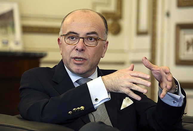 French interior minister Bernard Cazeneuve gestures Monday during an interview with the Associated Press, at his office in Paris. France's top security official says the country is tracking hundreds of people believed to be sleeper cells for terror organizations.