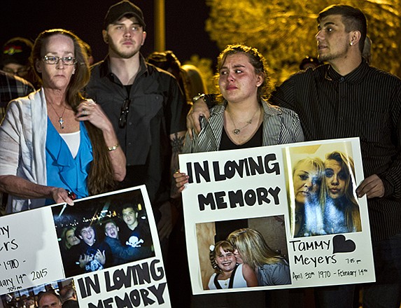 People participate in a candlelight vigil Tuesday for Tammy Meyers, who was taken off life support on Saturday after a shooting in Las Vegas. What police first described as a road rage-inspired shooting of an innocent mother of four has morphed into a more complex scenario.