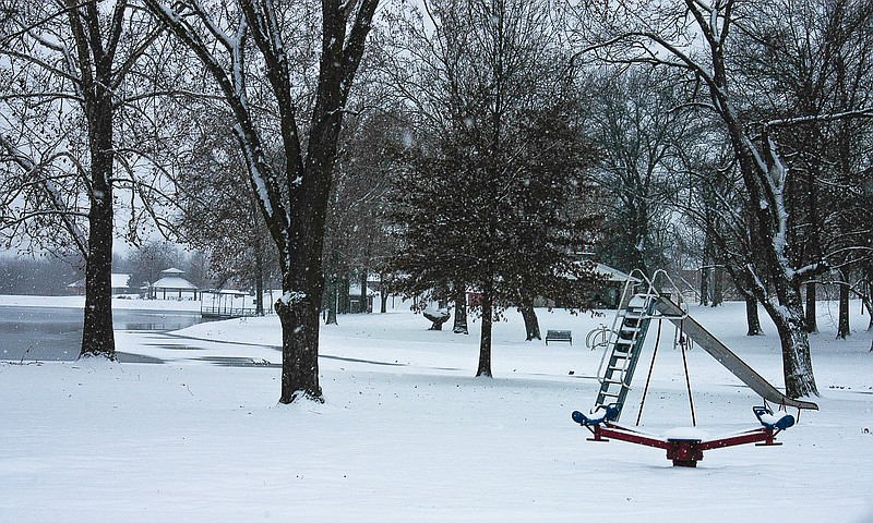 Playground equipment at Proctor Park goes unused in the snow and cold on Monday. 