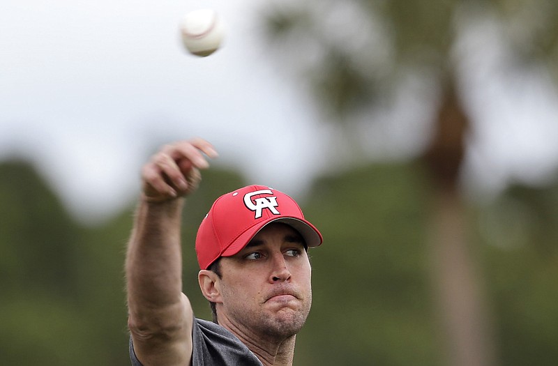 Cardinals pitcher Adam Wainwright throws long-toss during a practice session Wednesday in Jupiter, Fla.