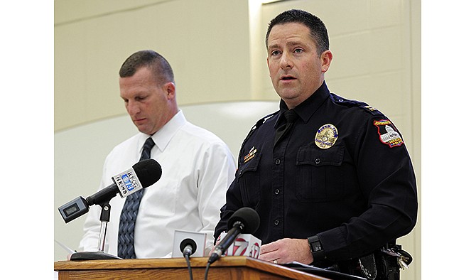 Capt. Doug Shoemaker, public information officer for the Jefferson City Police Department speaks to members of the gathered media on Wednesday afternoon as he and Investigation Section Lieutenant Steve Weaver, left, conduct a press conference following the arrest of three suspects in the murder of 52-year-old Johnny Evans in his High Street apartment on Sunday.