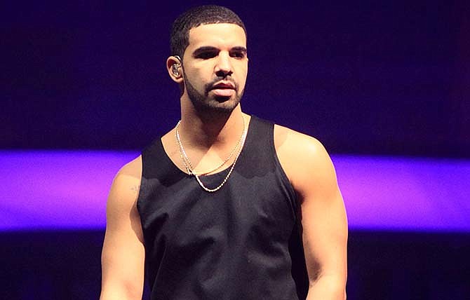 In this Dec. 18, 2013 file photo, rapper Drake performs in concert at the Wells Fargo Center in Philadelphia. The music streaming service Spotify said Wednesday that the rapper's new album, "If You're Reading This It's Too Late," set the record for most streams from an album in its debut week in the US. The album, released Friday, was streamed more than 17.3 million times in just three days.