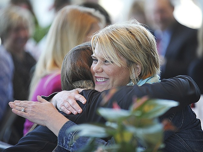 Jada Salmons, right, congratulates Lisa Jacobs Thursday during the monthly JCPS Staff Appreciation Breakfast at Miller Performing Arts Center. Salmons is a sixth-grade language arts instructor at Thomas Jefferson Middle School and recommended Jacobs for the recognition as special education teacher. 