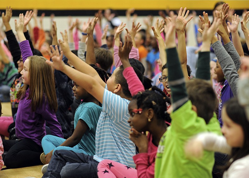 A group of second graders cheer loudly, along with the rest of their schoolmates, when asked "Who likes candy?" by Tooth Wizard during Delta Dental of Missouri's Land of Smiles interactive program Friday at Lawson Elementary School.