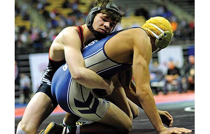 Jefferson City's Logan Moriarity holds on to Holt's Emilio Monsivais during their 160-pound match in the Class 4 state tournament on Thursday at Mizzou Arena.