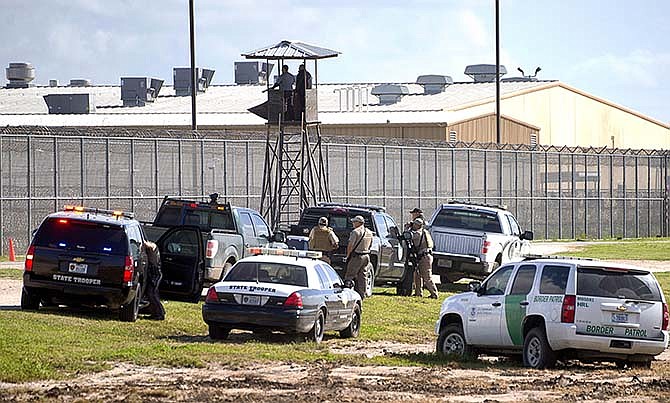 Law enforcement officials from a wide variety of agencies converge on the Willacy County Correctional Center in Raymondville, Texas on Friday, Feb. 20, 2015 in response to a prisoner uprising at the private immigration detention center. A statement from prison owner Management and Training Corp. said several inmates refused to participate in regular work duties early Friday. Inmates told center officials of their dissatisfaction with medical services.