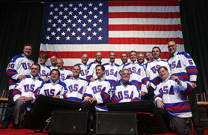 Members of the 1980 U.S. ice hockey team pose for photos after a "Relive the Miracle" reunion at Herb Brooks Arena on Saturday, Feb. 21, 2015, in Lake Placid, N.Y. Every surviving member of the hockey team returned to the hockey rink on Main Street they made famous with one of the most memorable upsets in sports history. 