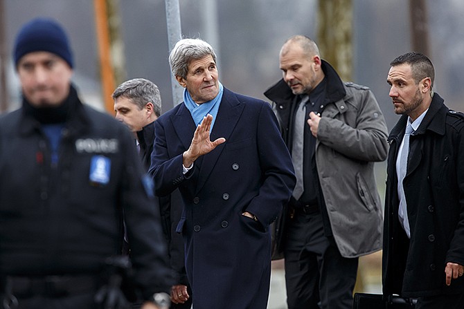 U.S. Secretary of State John Kerry, center, returns to his hotel after walking on the bank of Lake Geneva, following a bilateral meeting with Iranian Foreign Minister Mohammad Javad Zarif for a new round of nuclear talks in Geneva, Switzerland, Monday.