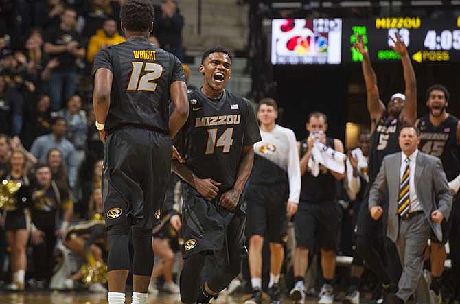 Missouri's Keith Shamburger, right, celebrates with teammate Namon Wright, left, during the second half of an NCAA college basketball game against Florida Tuesday, Feb. 24, 2015, in Columbia, Mo. Missouri won the game 64-52.