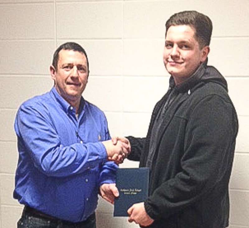 School Board President Jay VanDieren presents Cody Rayburn with a California High School diploma after he completed the requirements under the Missouri Option Program.