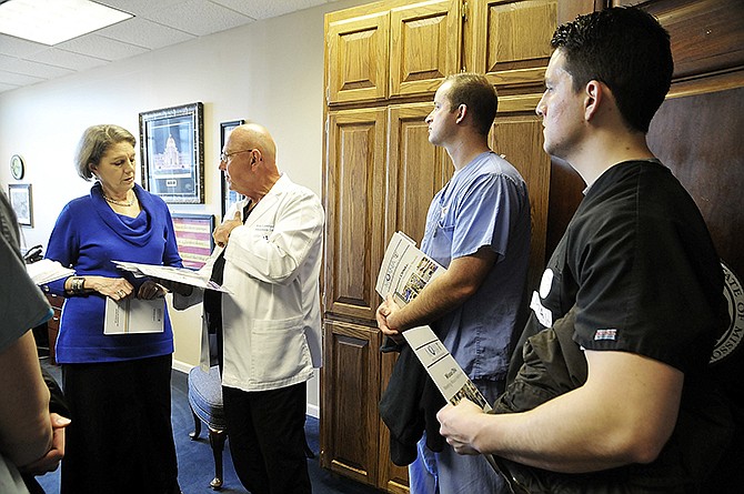 After an early morning rally Wednesday, several certified registered nurse anesthetists scattered throughout the Capitol to visit with legislators or their staffs to ask them to oppose SB-217 and HB-393. From right, Casey Brooks and Tony Sanders, both CRNAs from St. Louis, listen as Ron Lenninger, a nurse anesthetist at Capital Region Medical Center, talks to Carolyn Loethen, legislative assistant to Sen. Mike Kehoe, R-Jefferson City. Also in the group were Kristen Richter, Columbia (formerly from Jefferson City) and Jessica Premis of St. Louis.