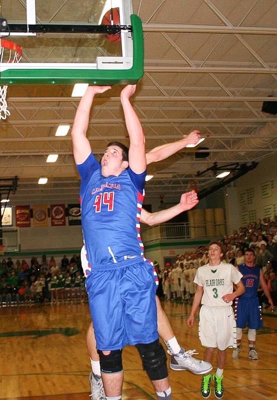 California senior Damon Shaw puts up a shot against Blair Oaks in their conference game on Tuesday, Feb. 17. The host Falcons won, 71-66, and earned a share of the conference title with California.