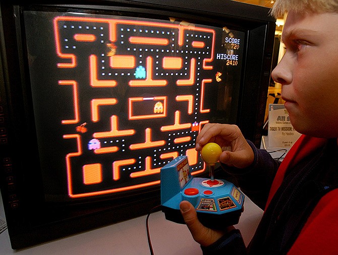 A youth tries a Ms. Pac-Man TV game in New York in 2004. Computers already have bested human champions in Jeopardy! and chess, but artificial intelligence now has gone to master an entirely new level: Space Invaders. Google scientists have cooked up software that can do better than humans on dozens of Atari video games from the 1980s, like video pinball, boxing and breakout.