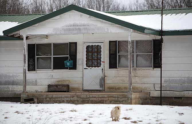 Tape is placed on one of the doors of a home near Tyrone, Mo., on Friday morning, Feb. 27, 2015. A gunman killed seven people and wounded an eighth person in an overnight house-to-house rampage in the small town in the Missouri Ozarks before apparently committing suicide in a vehicle, authorities said Friday. The victims were found in four homes in Tyrone, about 40 miles north of the Arkansas line. The 36-year-old gunman was discovered in a neighboring county, dead of what appeared to be a self-inflicted gunshot wound, Missouri Highway Patrol Sgt. Jeff Kinder said.